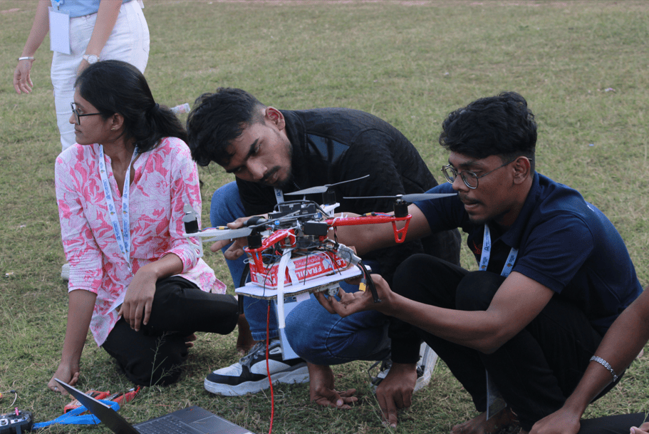 Teammates assembling and configuring the drone